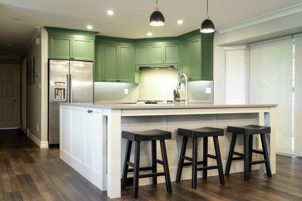 A modern newly renovated kitchen with a sink in the L-shaped island.