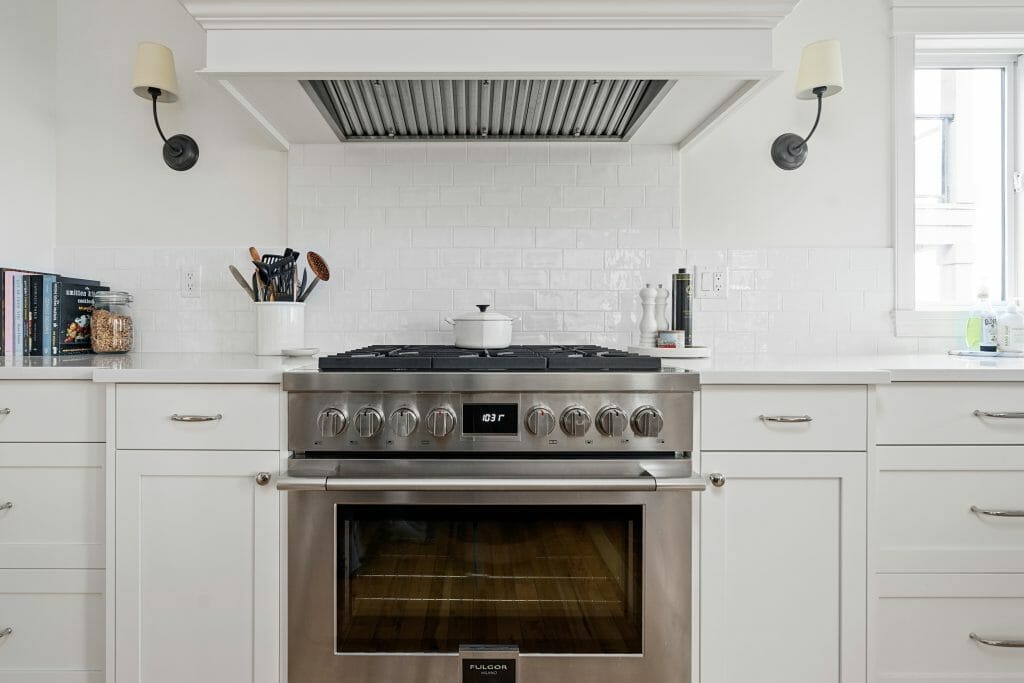 Close-up of a stainless steel gas range in a newly renovated kitchen.