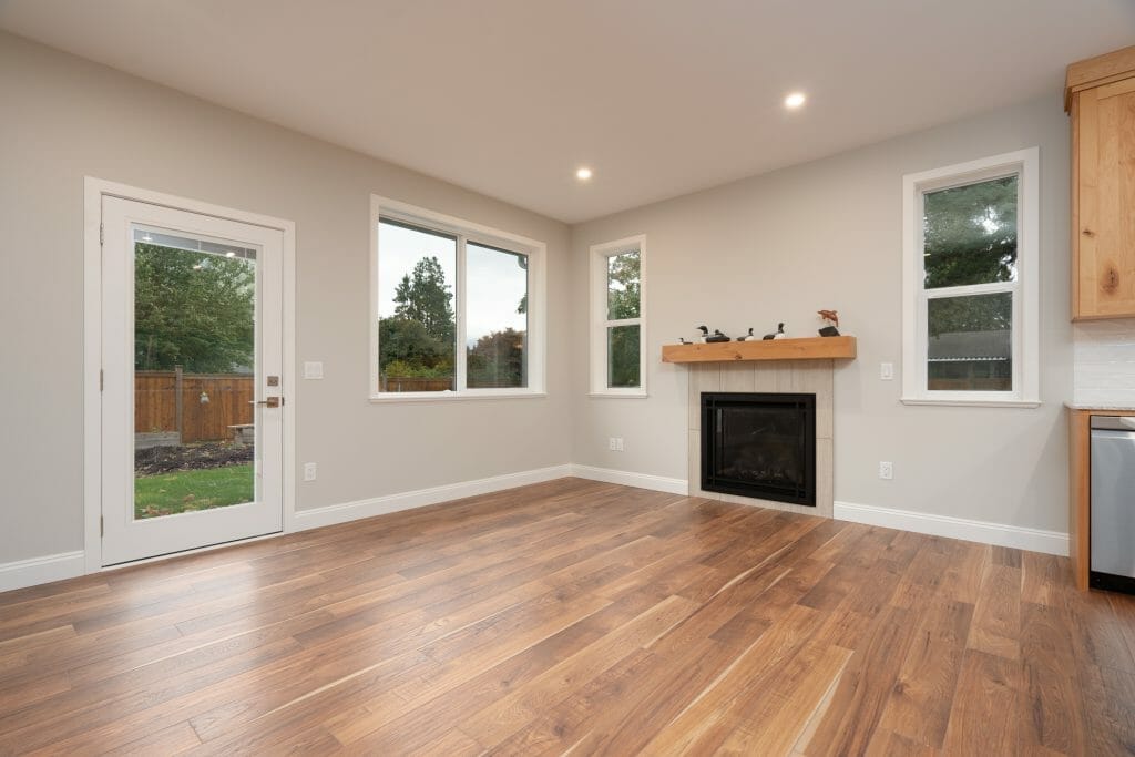A refinished garden living room with large windows and a glass door for garden access.