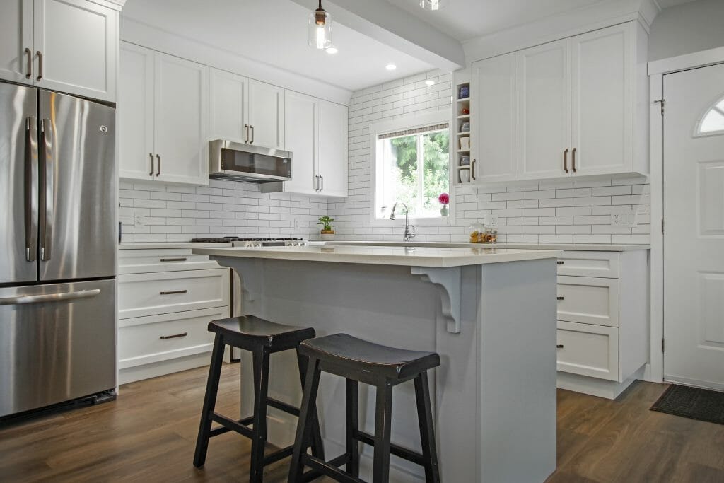 A corner kitchen renovation with a window above the sink.