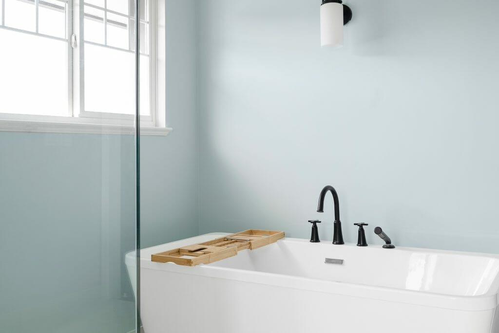A bathroom renovation with pastel aqua coloured walls and a large soaker bathtub.