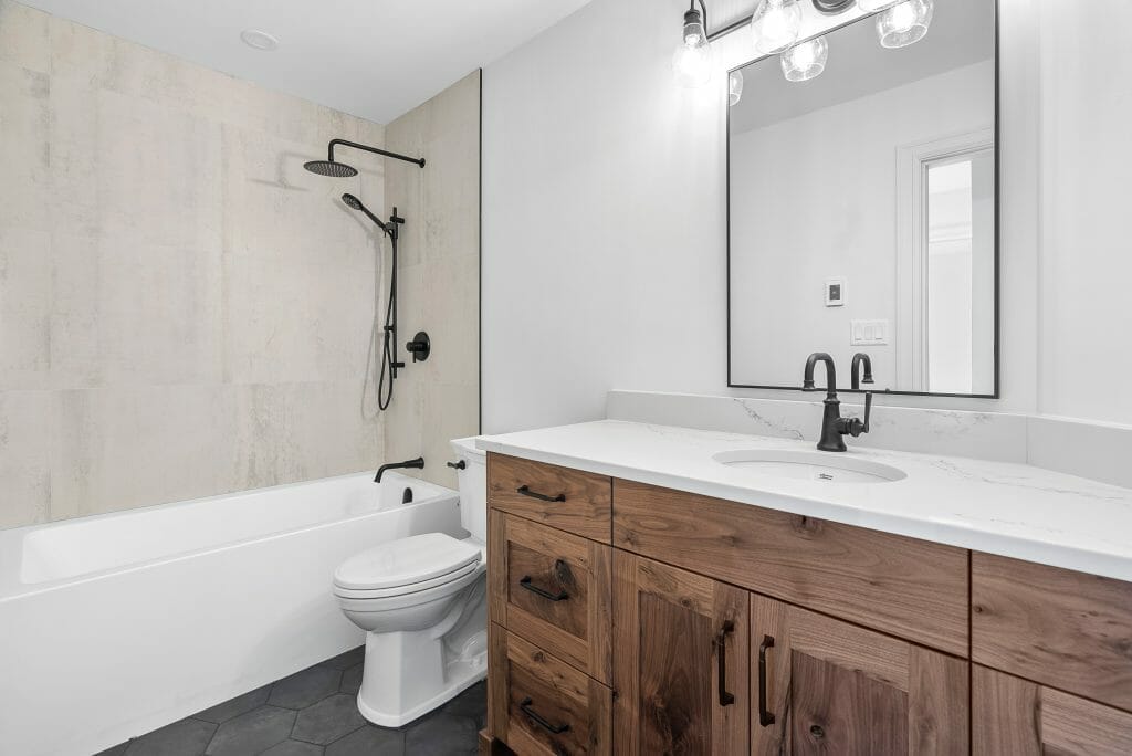 Large newly renovated bathroom with bathtub, shower and toilet.