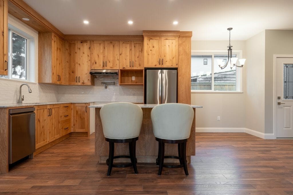 A refinished kitchen in stained pine with hardwood flooring and a breakfast nook.